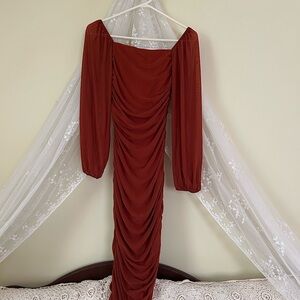 This bidicon, midi dress is in a rich pumpkin color.